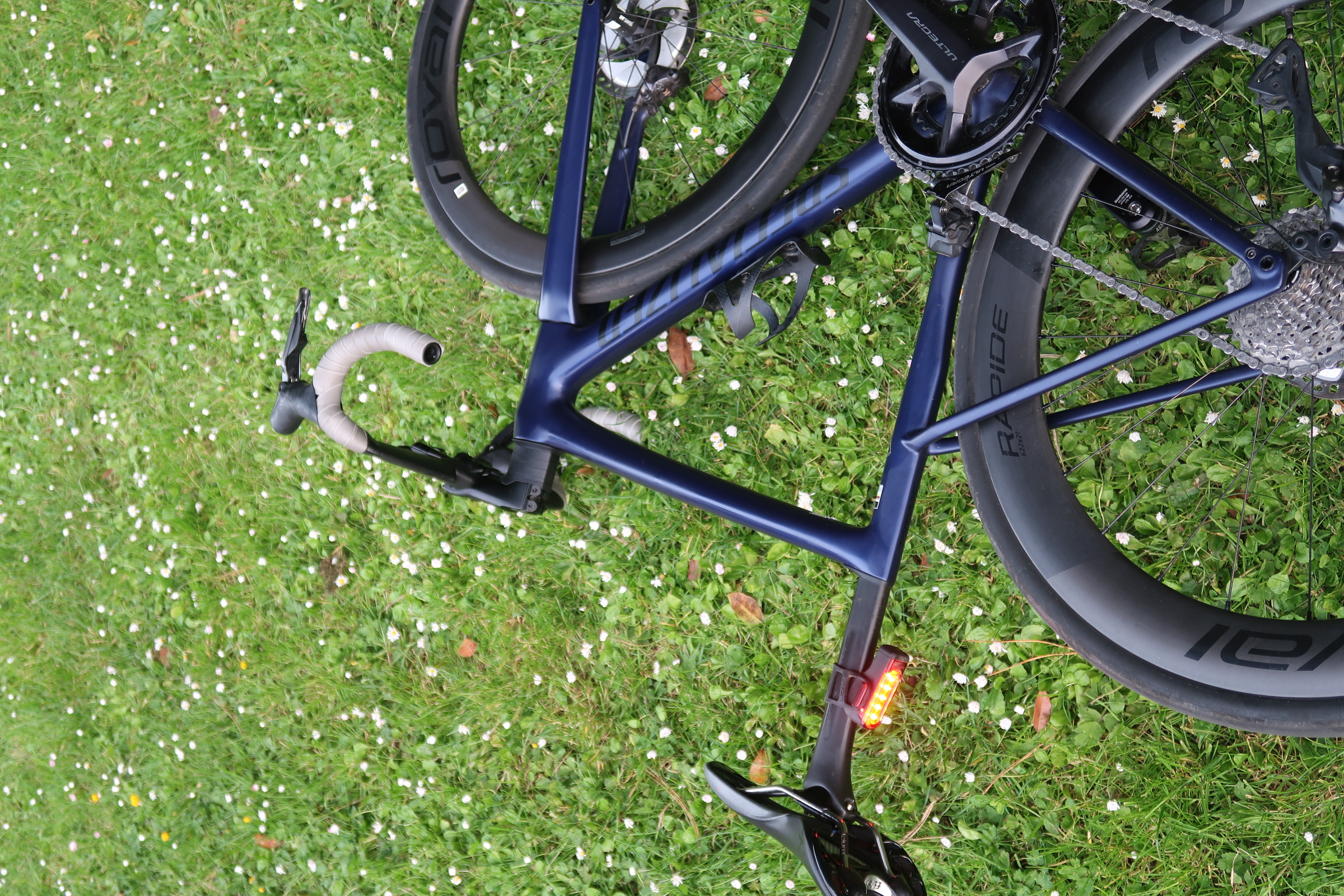 A road bike resting in a flower-covered meadow