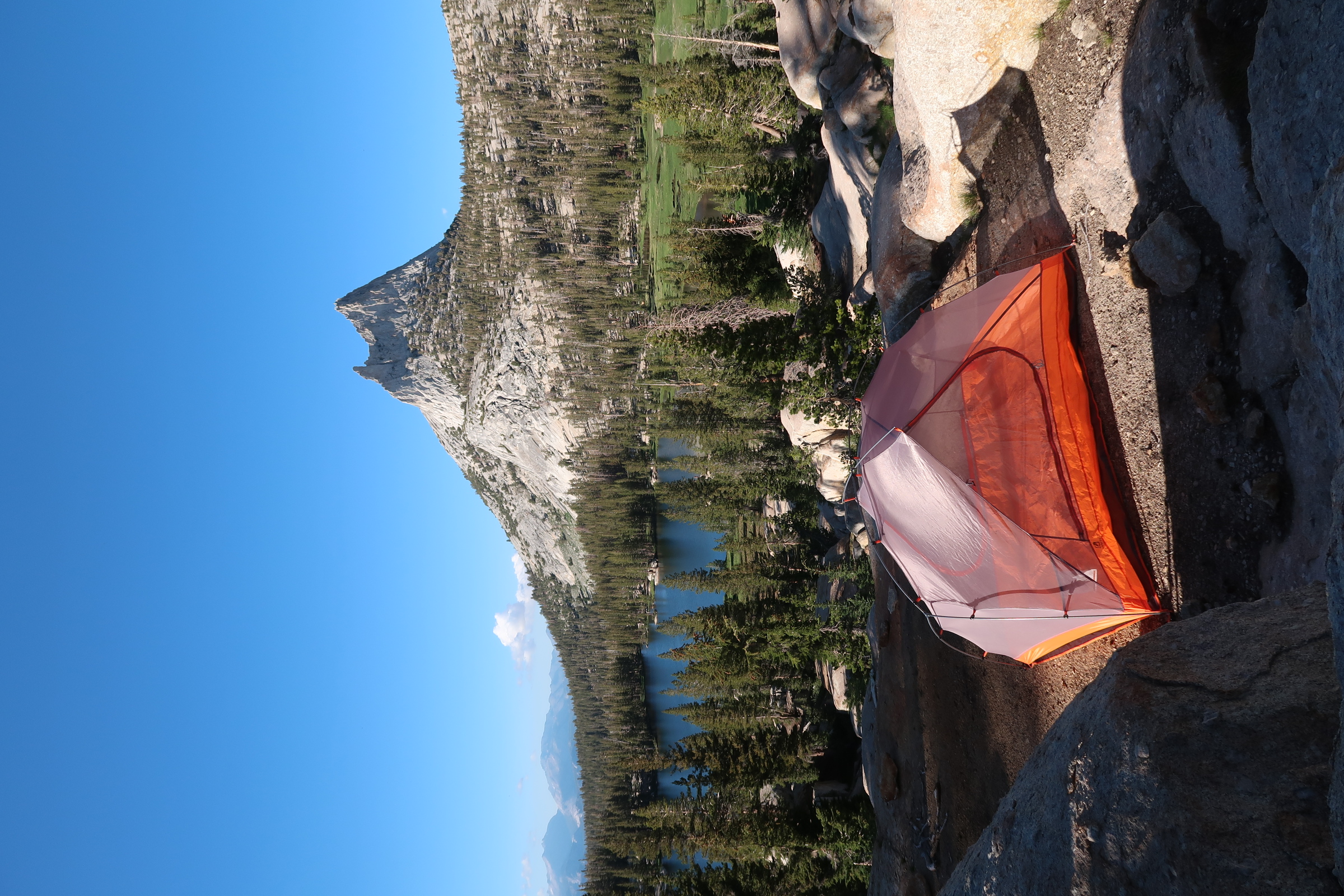 A tent below a mountain peak