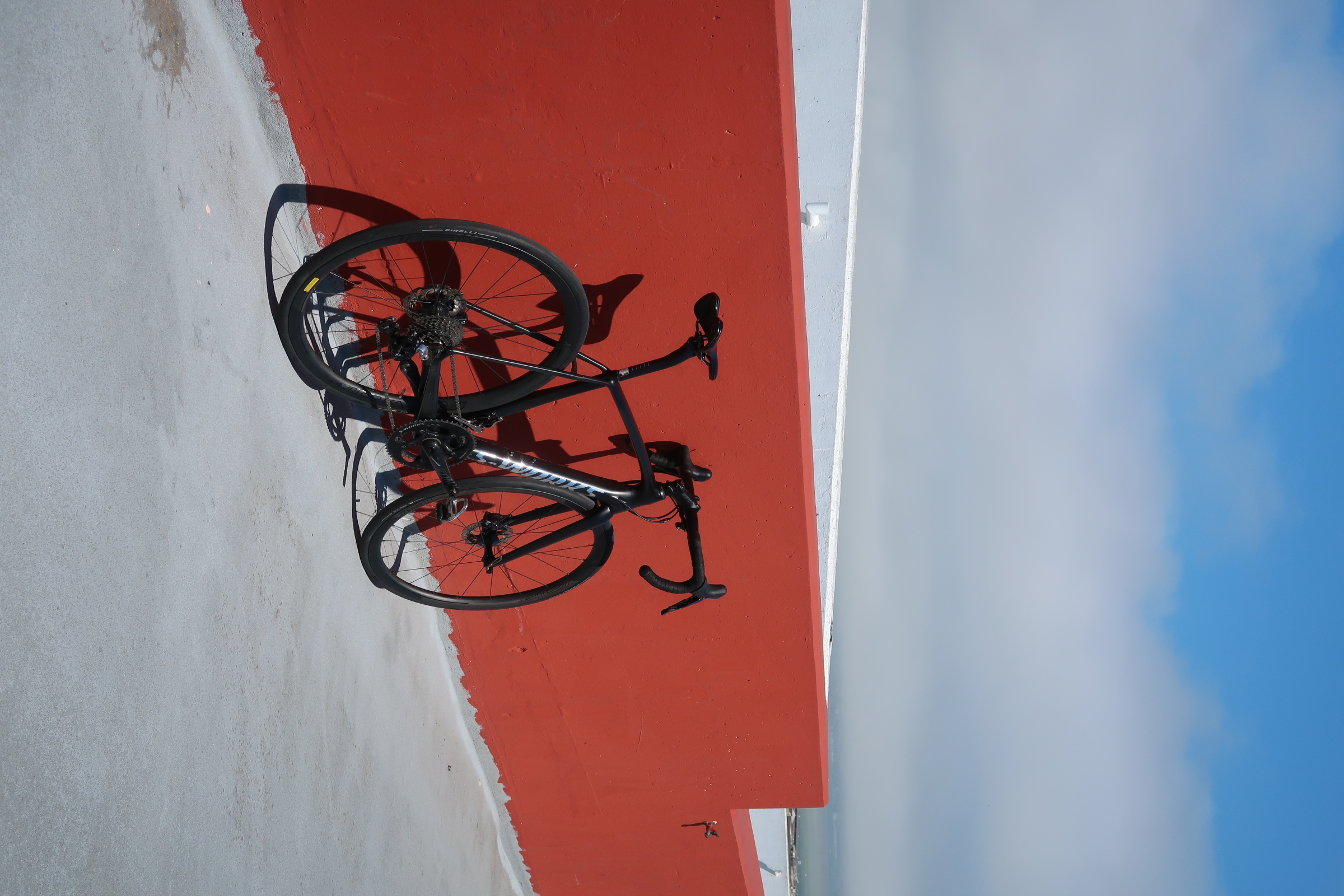 A road bike against a red wall